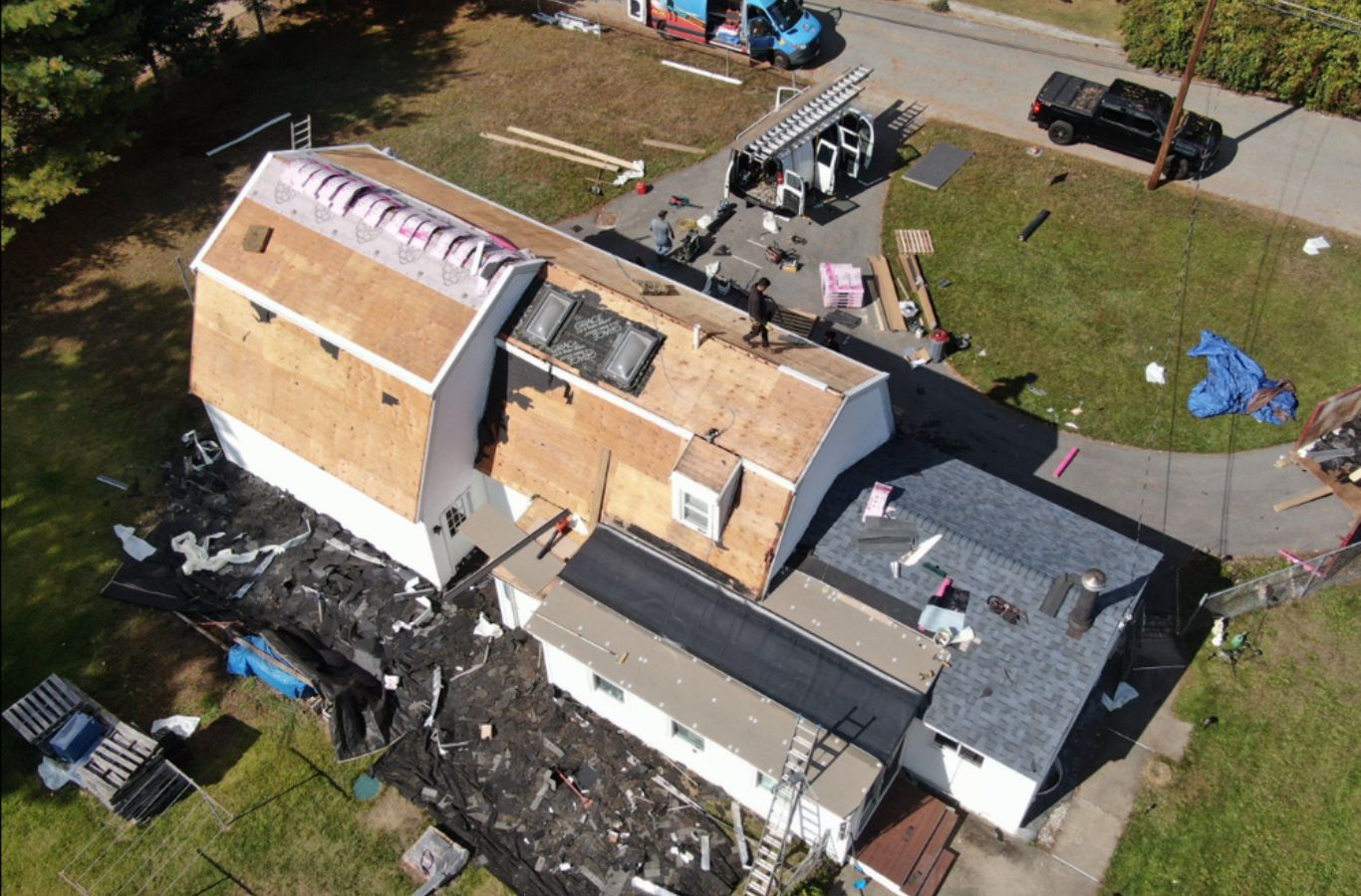 A Mighty Dog Roofing of Greater Middlesex County technician performing roof repair in Westford, MA, using durable materials for lasting protection.